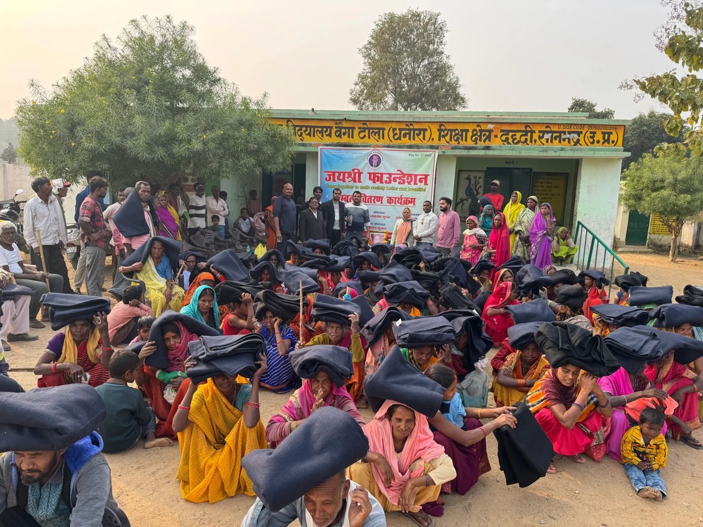 Villagers receiving blankets from Jayshri Foundation in Dhanaura village